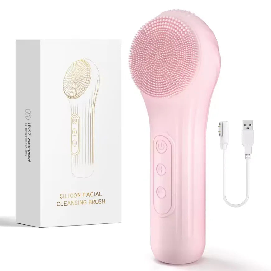 Pink silicone facial cleansing brush with packaging and USB cable on a white background