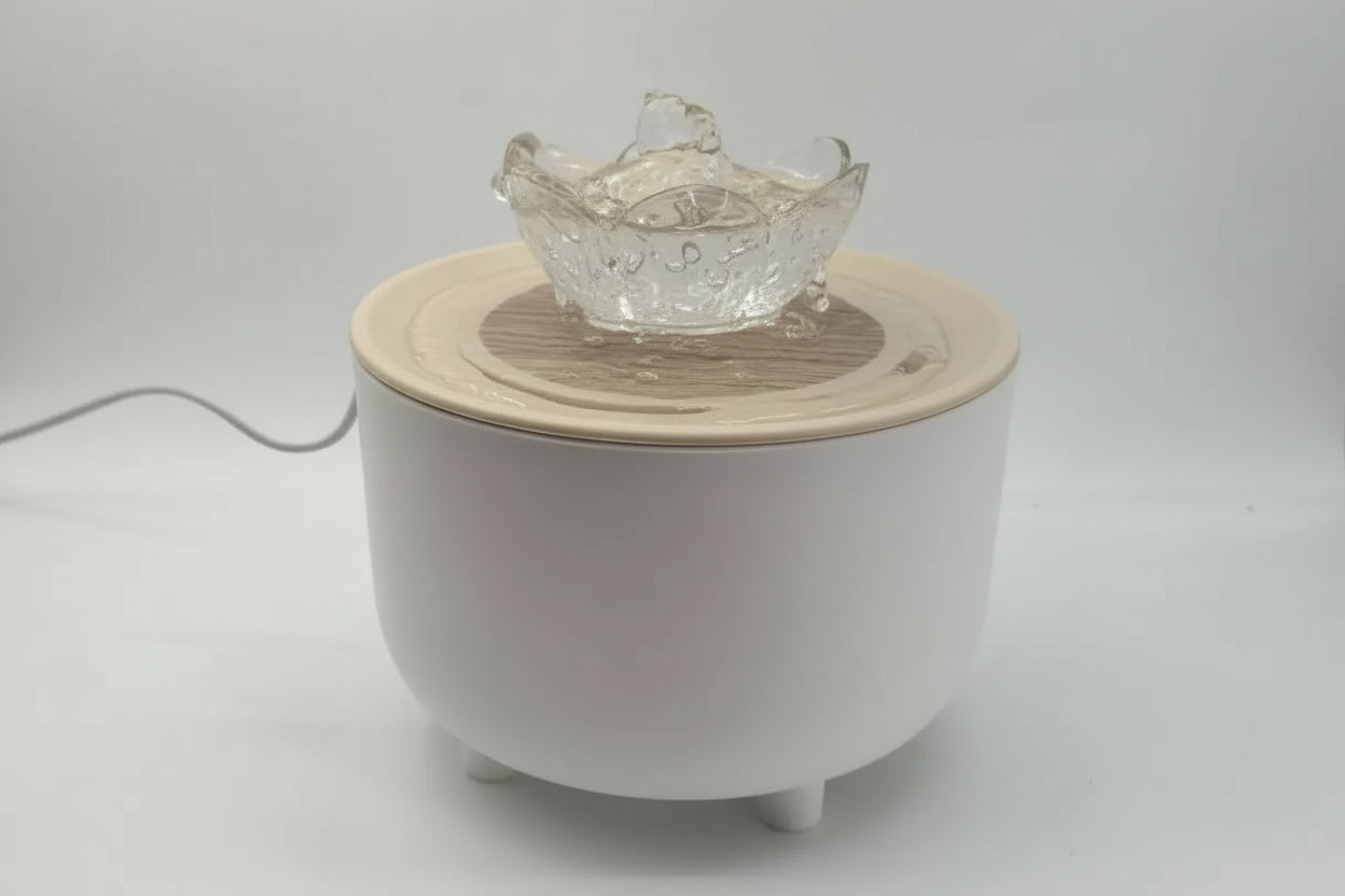 White ceramic diffuser with a glass bowl on a light gray background