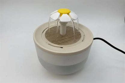 Small white and yellow device resembling a flower on a white background